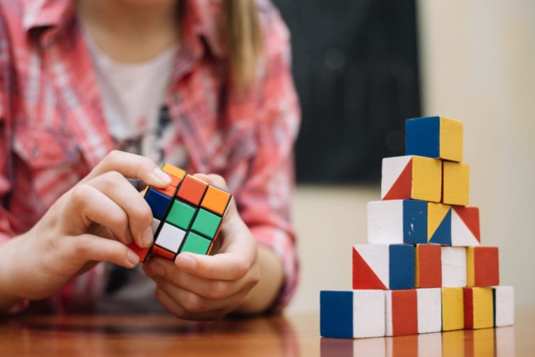 girl-playing-with-cube-puzzle